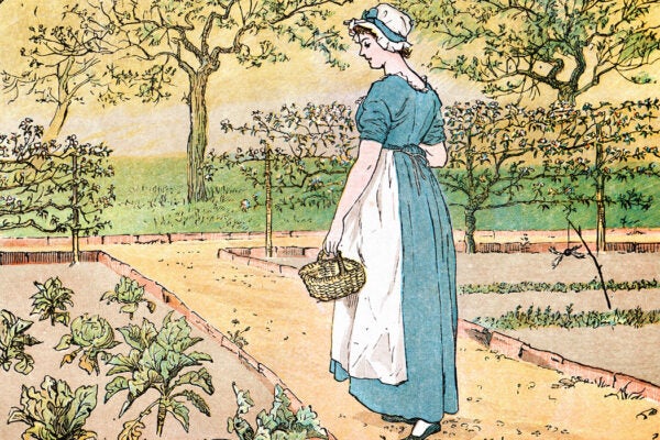 Young woman walking through a vegetable garden