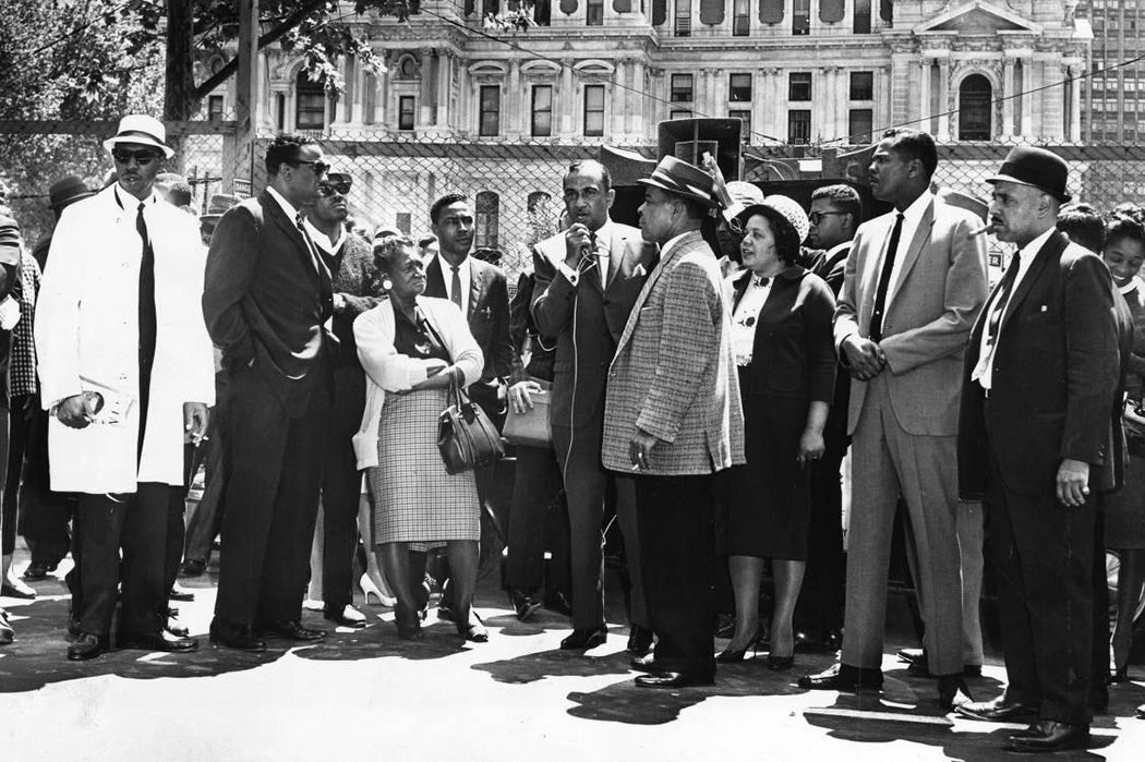 Cecil B. Moore, president of the Philadelphia chapter of the National Association for the Advancement of Colored People, uses a hand microphone to talk to people gathered this afternoon at the Reyburn Plaza construction site for the Municipal Services building.