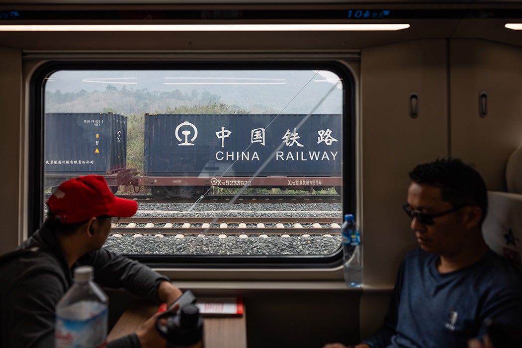 LUANG PRABANG, LAOS - APRIL 09: The China-Laos Railway passes by a China Railway cargo shipment on April 09, 2024 in Luang Prabang, Laos. The China-Laos railway, a key project of China's Belt and Road Initiative, is a high-speed railway connecting Kunming, the capital of China's Yunnan province, to Vientiane, the capital of Laos. This railway is the biggest public infrastructure project ever undertaken by Laos, with a total length of 1,035 kilometers and a cost of US$5.9 billion, which is equivalent to around one-third of Laos' gross domestic product in 2019. The railway is dedicated to both passenger and freight traffic services, creating a new link between Laos and China, the former's neighbor and closest partner. The Laos section of the railway is part of a vision to build a Pan-Asia railway that will ultimately connect China, Laos, Thailand, Malaysia, and Singapore, improving the efficiency of goods movement for export-driven economies along the route, opening up travel and extending China's influence deep into Southeast Asia. (Photo by Lauren DeCicca/Getty Images)