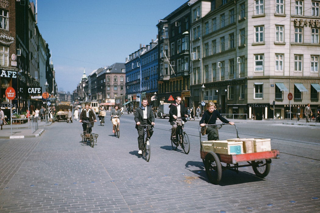 Men ride their bikes, down a cobblestone road in Copenhagen, Denmark in July 3, 1946.