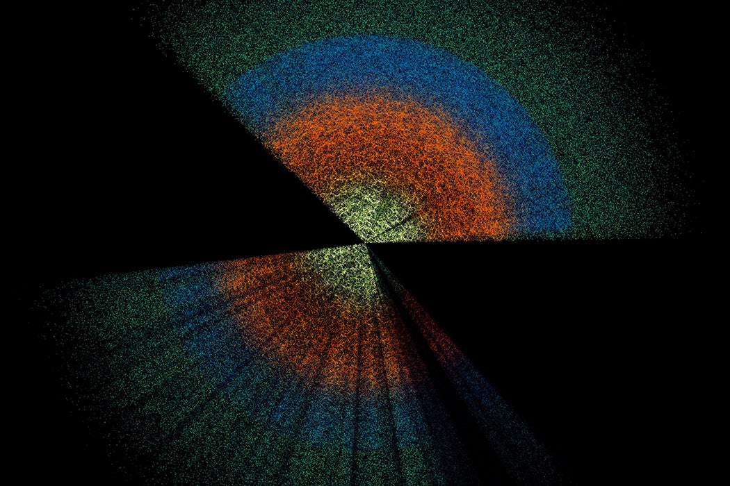 Two broad wedges made of thousands of tiny dots in colorful bands on a black background.