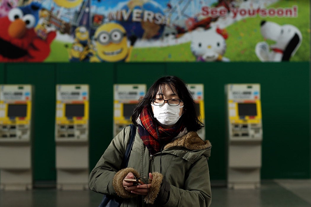 A woman wearing a face mask walks inside the Universal Studio station on March 05, 2020 in Osaka, Japan.