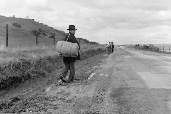 "The trek of bums, tramps, single transients and undesirable indigents out of Los Angeles County because of police activity." Photographed by Dorothea Lange.